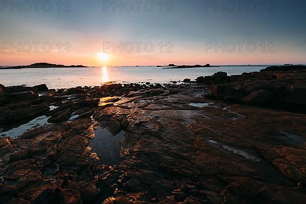 Rocks on the beach of Port Blanc in the evening light