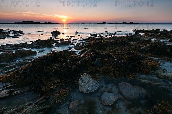 Rocks on the beach of Port Blanc in the evening light