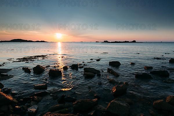 Rocks on the beach of Port Blanc in the evening light