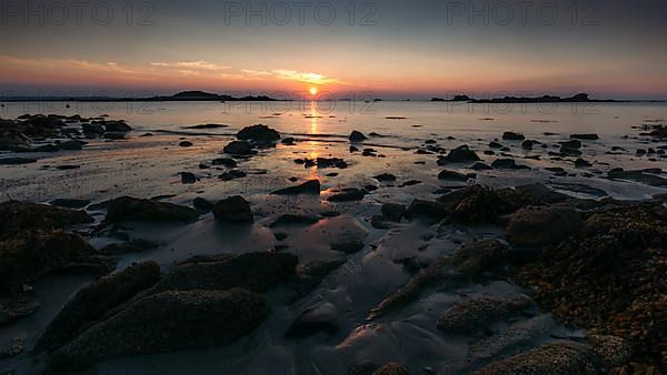 Rocks on the beach of Port Blanc in the evening light