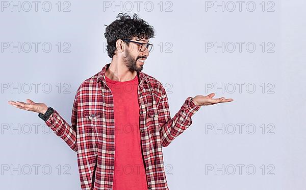 Handsome man balancing the palms of his hands, Person comparing with the palms of his hands