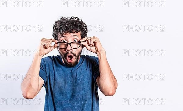 Surprised handsome man taking off his glasses, Person taking off his glasses surprised by a promotion