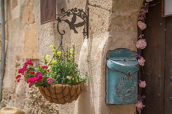Old letterbox and flower decoration at house entrance, Sineu