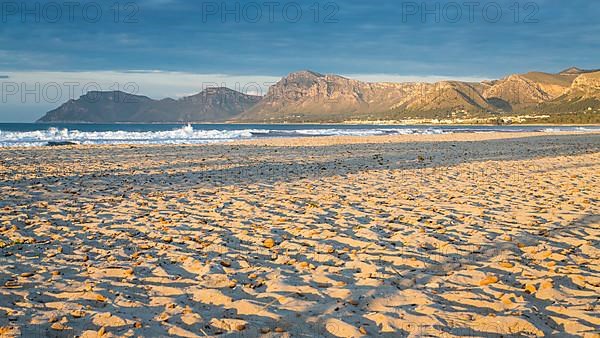 Sandy beach beach Playa Sa Canova in Son Serra de Marina, behind Serres de Llevant mountains