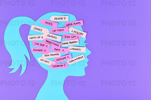 Concept for mental load with woman's head silhouette with multiple tasks on notes,