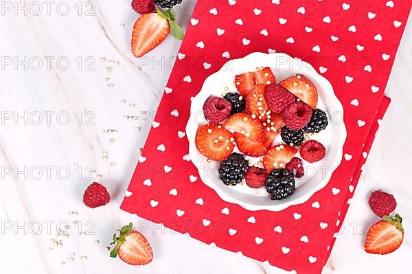 Top view of berry mix yogurt bowl with strawberry, raspberry and blackberry fruits and puffed quinoa