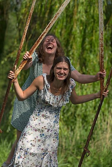 Two young girls swinging, Mecklenburg-Western Pomerania