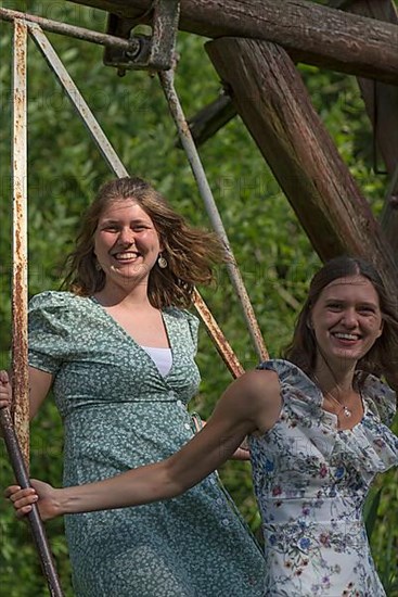 Two young girls swinging, Mecklenburg-Western Pomerania