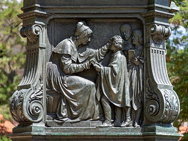 Luther monument by the sculptor Adolf von Donndorf from 1895 on Karlsplatz in Eisenach. The plinth motif shows the reformer Martin Luther,