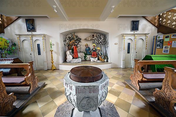 Baptismal font and figures of saints, praying disciples on the Mount of Olives