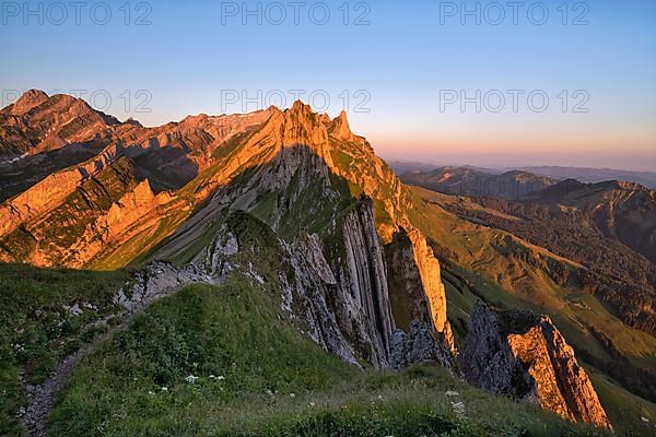 View of the Alpstein mountains in Appenzell, cloudless sky in the morning light