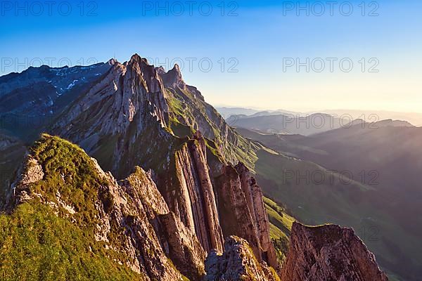 Alpstein mountains with ridge in the evening light, cloudless sky over Appenzellerland