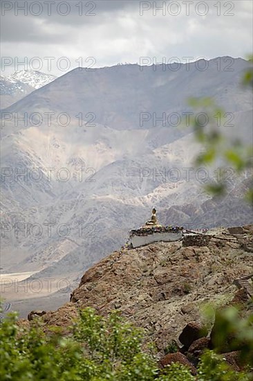 Maitreya Buddha at Hemis Gompa, Shang mountain range in the background