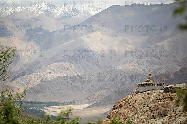Maitreya Buddha at Hemis Gompa, Shang mountain range in the background
