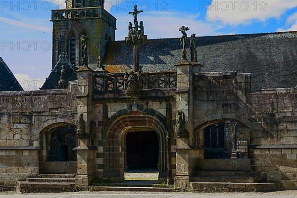 Enclosed parish Enclos paroissial Eglise Saint-Salomon de La Martyre with Gothic Flamboyant-style triumphal arch, Finistere department