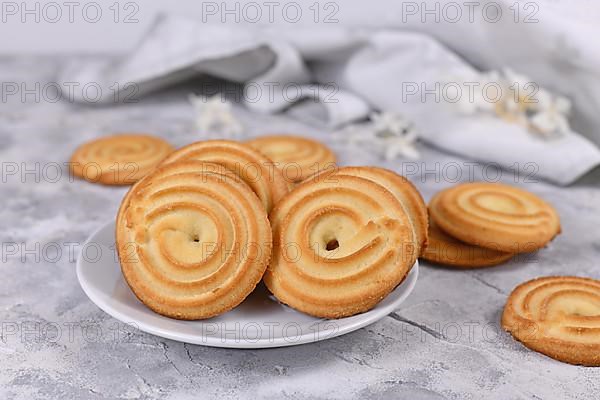 Ring shaped spritz biscuits, a type of German butter cookies made by extruding dough with a press fitted with patterned holes
