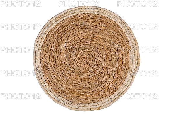 Top view of round weave wicker placemat on white background,