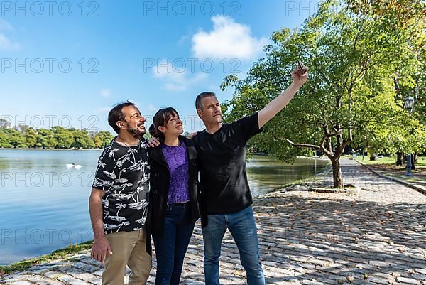 A group of friends taking selfies outdoors,