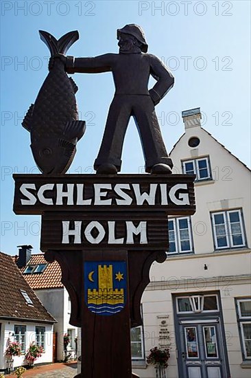 Woodcarving Fisherman with Fish at the Entrance to the Historic Fishermen's Settlement Holm, Schleswig