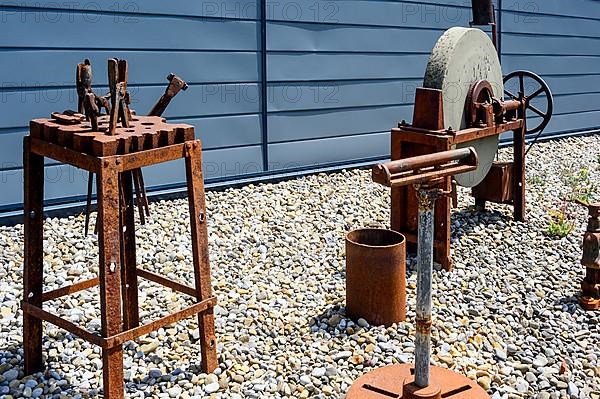 Rusty forging tool and old grindstone with rusted mechanics, Buchenberg