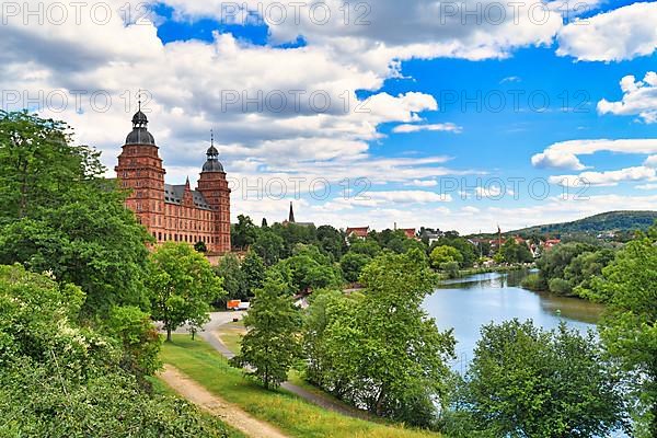 Beautiful view over German city Aschaffenburg with Main river, palace called Schloss Johannisburg and green park on sunny summer day