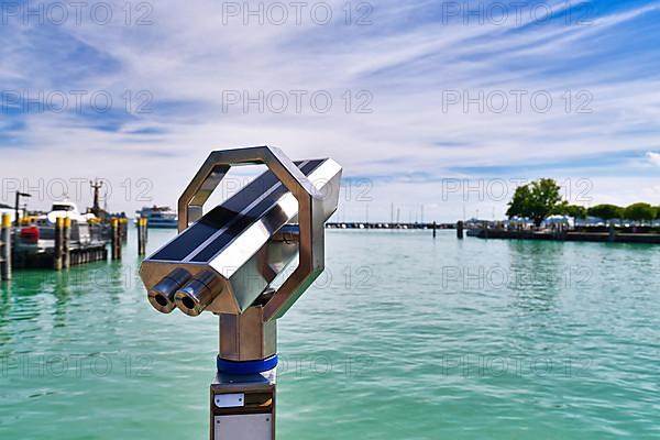 Telescope binoculars at Lake Constanze at Konstanz harbor, a popular travel destination for tourists in Europe