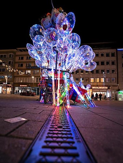 Colourful lights at balloon stand at night, Pforzheim