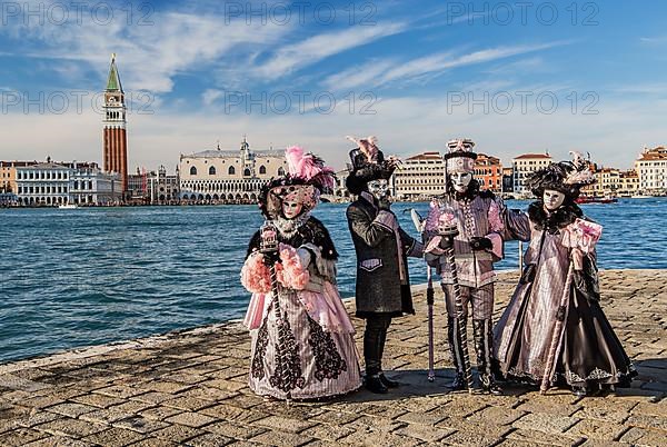 Carnival masks in front of the panorama of the city with Campanile and Doge's Palace, Venice