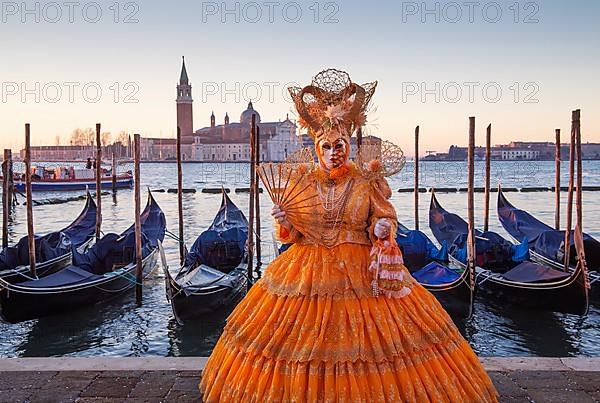 Carnival mask on the waterfront at sunrise, Venice