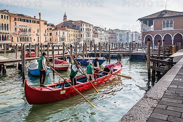 Rowing boat with carnival masks at the market hall on the Grand Canal, Venice