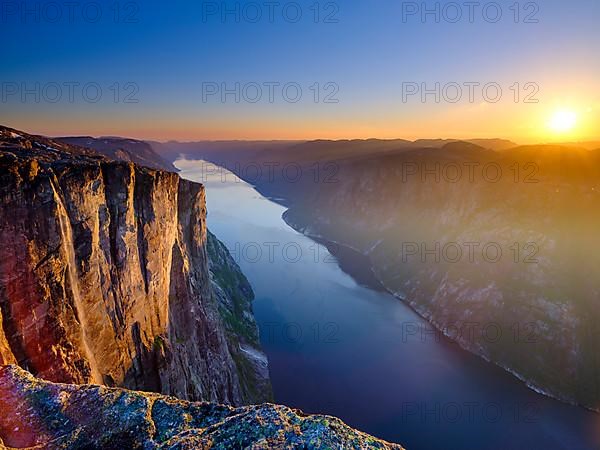 Rock face of Kjerag above the Lysefjord in the evening light, Lyseboten