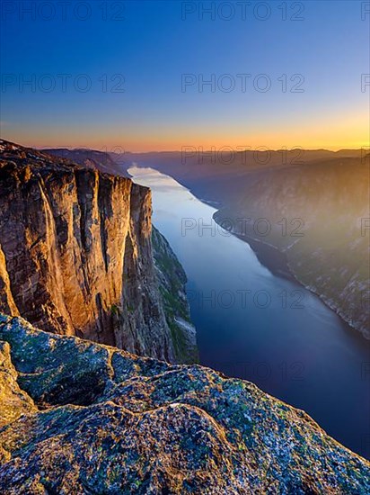 Rock face of Kjerag above the Lysefjord in the evening light, Lyseboten