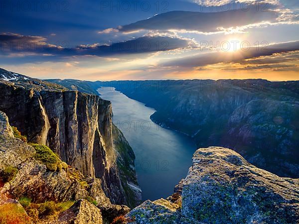 Rock face of Kjerag above the Lysefjord in the evening light, Lyseboten