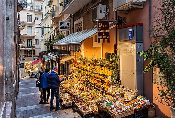 Old town alley with fruit and souvenir stand, Taormina