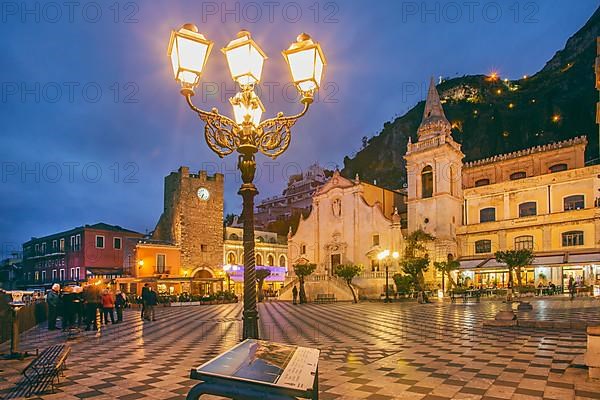 Belvedere Piazza IX Aprile with clock tower and church of San Giuseppe at dusk, Taormina