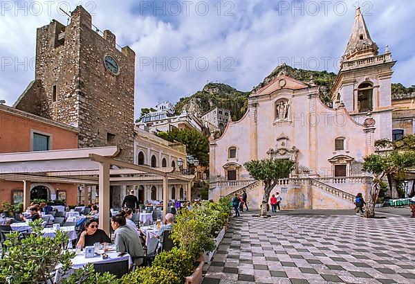 Belvedere Piazza IX Aprile with street cafe, clock tower and church of San Giuseppe