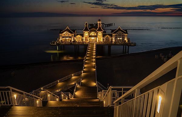 Illuminated pier Sellin in the sunrise on the island of Ruegen, Germany