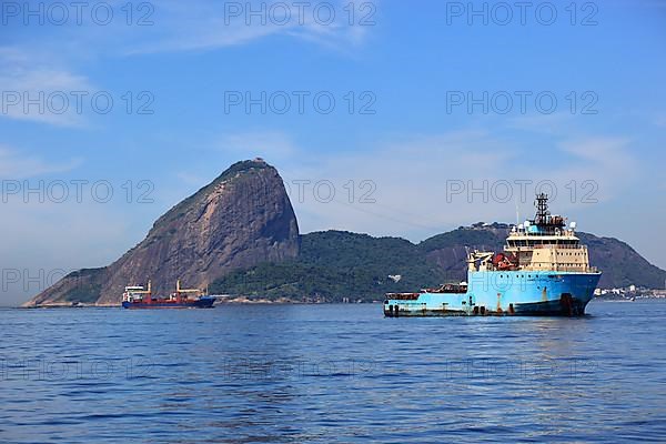 Cargo ferry in the bay. Baia de Guanbara Bay in the east of Rio de Janeiro, with a view of Sugar Loaf Mountain