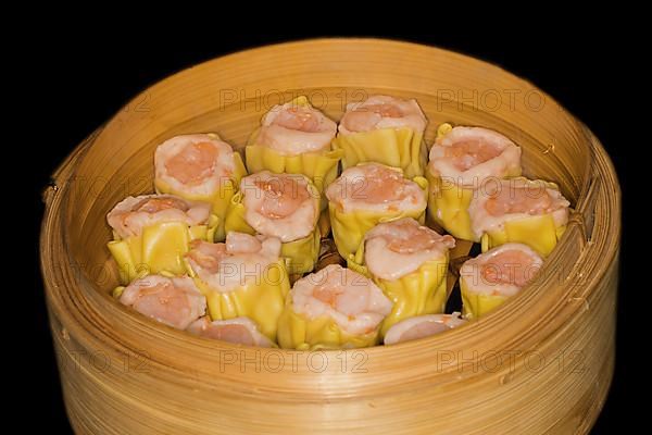 Dim Sum with fish farce and prawns, food photography with black background