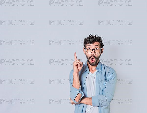 Surprised man pointing up with a new idea, Amazed person pointing an advertisement up