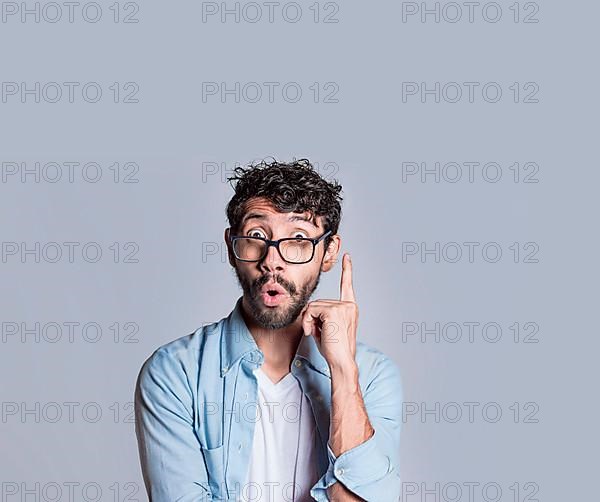 Amazed person pointing an advertisement up, Amazed people pointing with a hand up