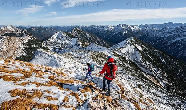 Two mountaineers on the rocky snowy ridge of the Ammergauer Hochplatte, view towards Loesertaljoch