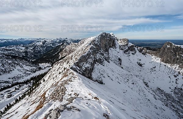 Snow-covered rocky mountain ridge, behind peak of Kraehe