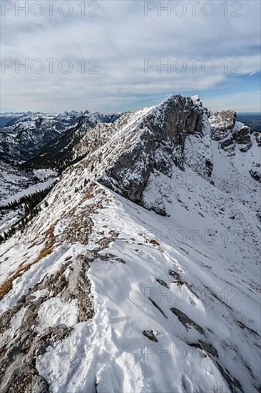 Snow-covered rocky mountain ridge, behind peak of Kraehe