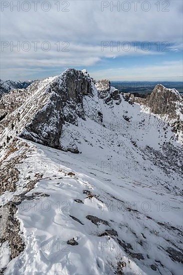 Snow-covered rocky mountain ridge, behind peak of Kraehe