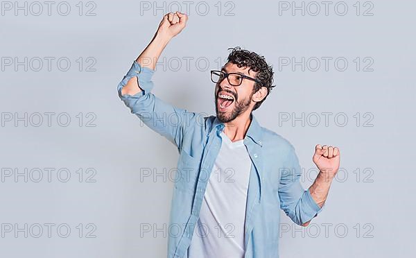 Handsome man raising his hand in victory isolated, Person celebrating and raising his hand in victory