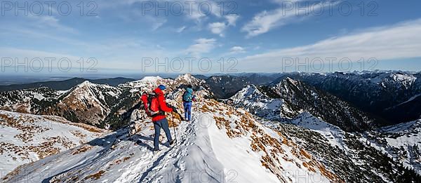 Two mountaineers on the rocky snowy ridge of the Ammergauer Hochplatte, view towards Loesertaljoch