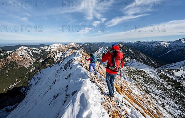 Two mountaineers on the rocky snowy ridge of the Ammergauer Hochplatte, view towards Loesertaljoch