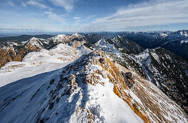 Narrow rocky snowy ridge of the Ammergauer Hochplatte, view towards Loesertaljoch