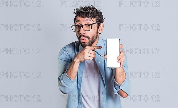 Amazed man showing mobile screen, Shocked person showing and pointing at his smartphone screen